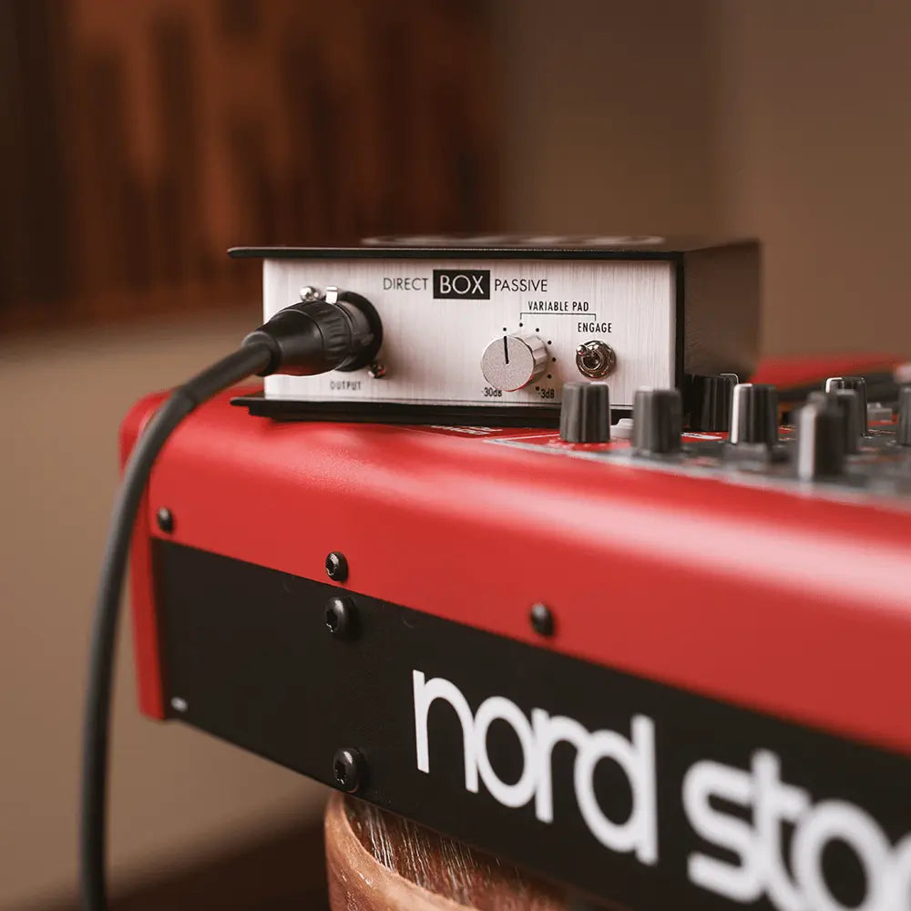 Red and black audio equipment with a Direct Box Passive unit on top Warm Audio